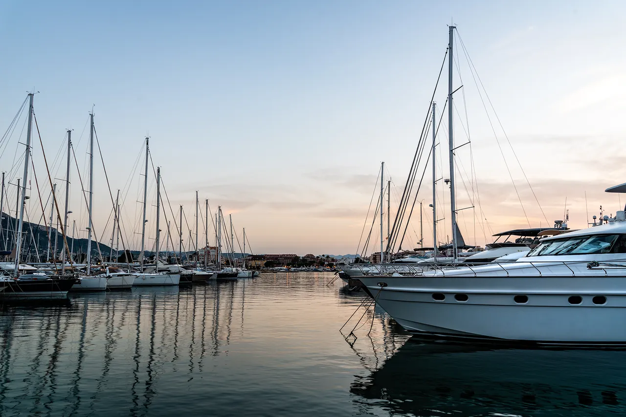 Veleros y barcos a motor amarrados en un puerto deportivo